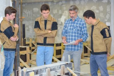 Teacher with three students in practical class